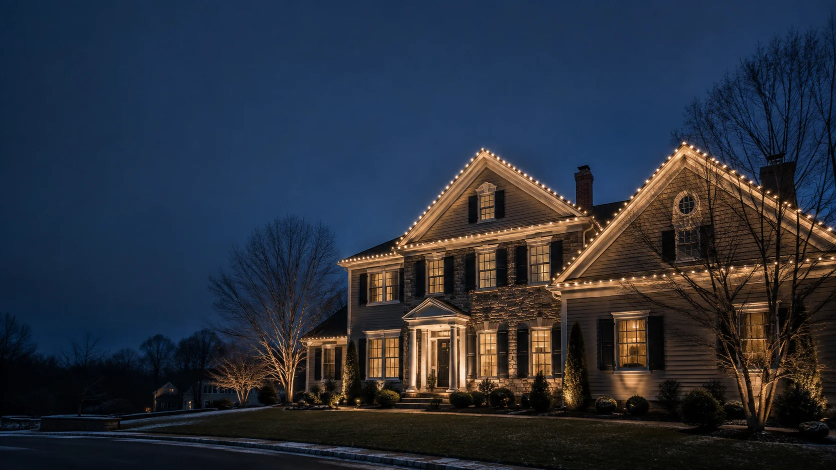 Design illustration of a traditional home outlined with warm white Christmas lights at dusk